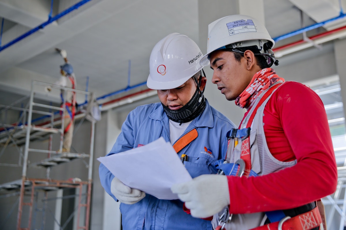 two workers looking at plans