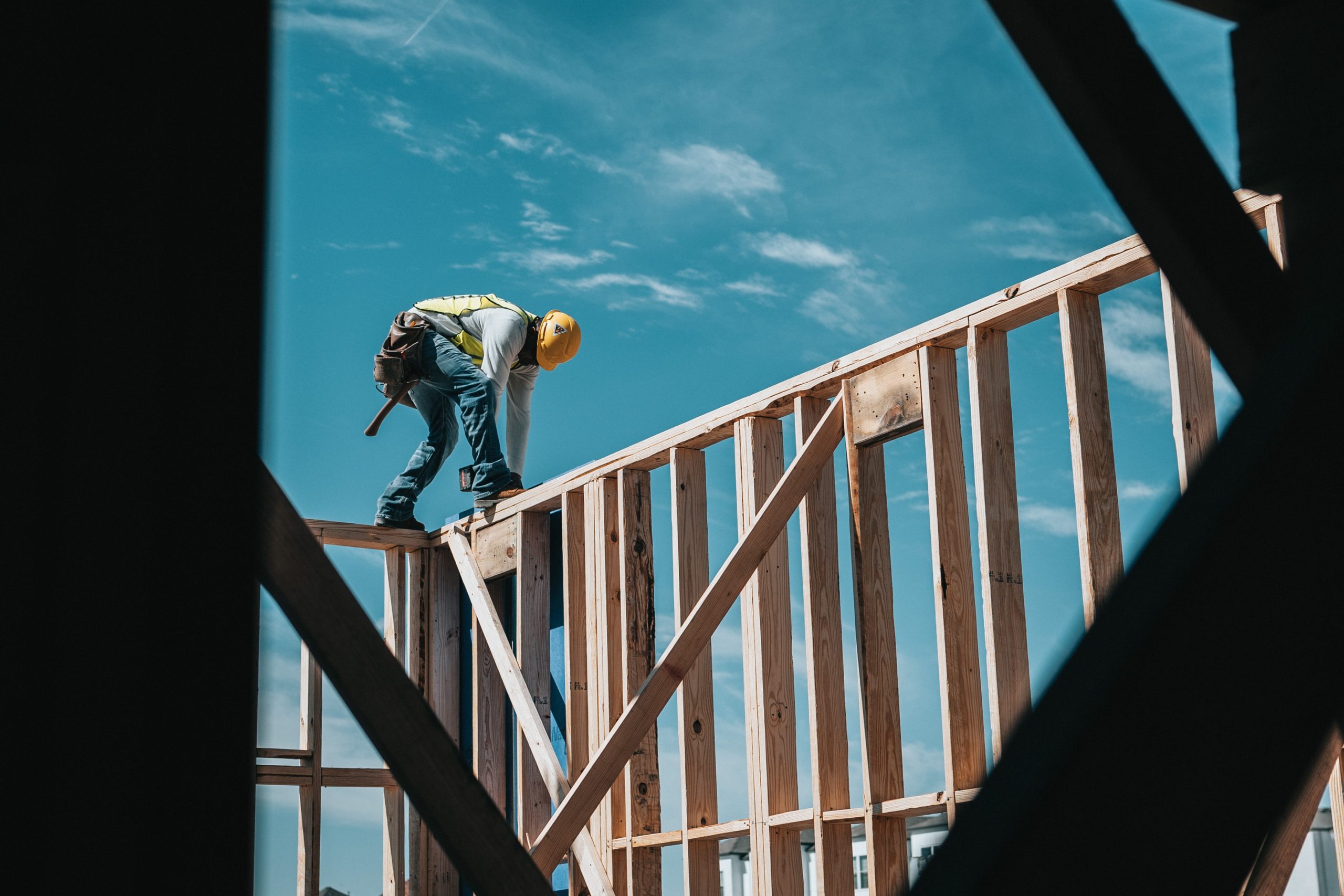 worker using tools on building frame